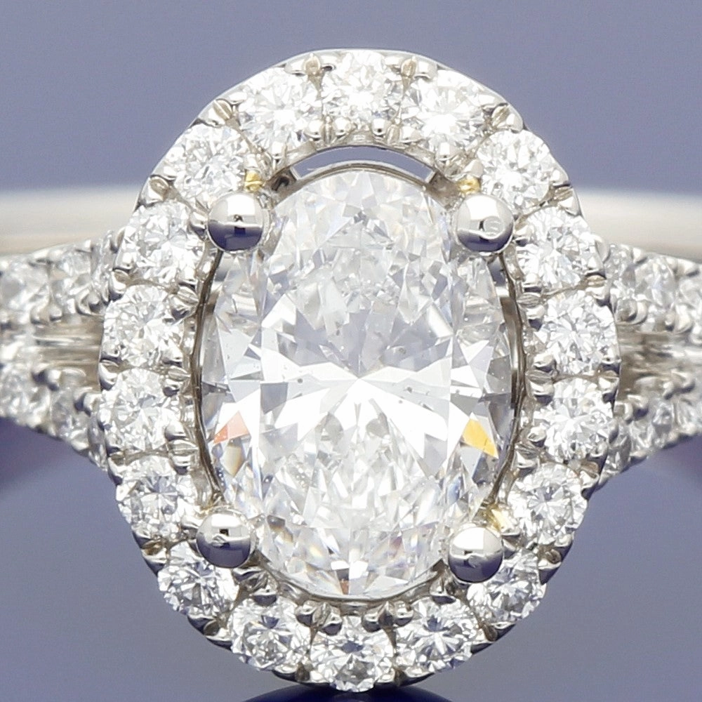Platinum Certificated Oval Cut Diamond Halo Ring with Diamond Set Shoulders