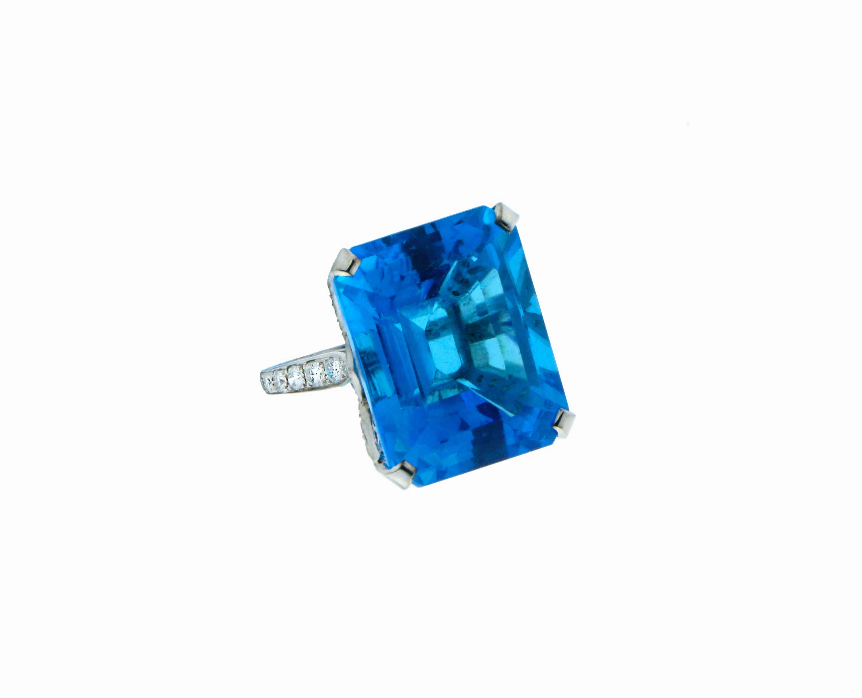 Platinum ring set with diamond and blue Topaz