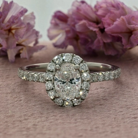 Pre-loved Platinum Certificated 0.60ct Oval Cut Diamond Shoulders Halo Ring