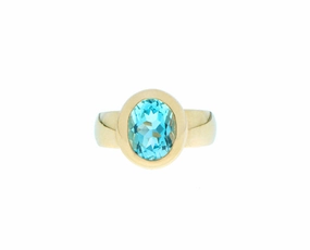 Yellow gold ring with an oval blue topaz